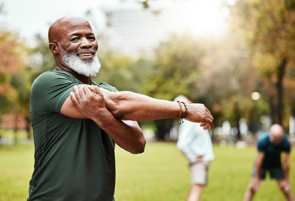 senior man in a park stretching