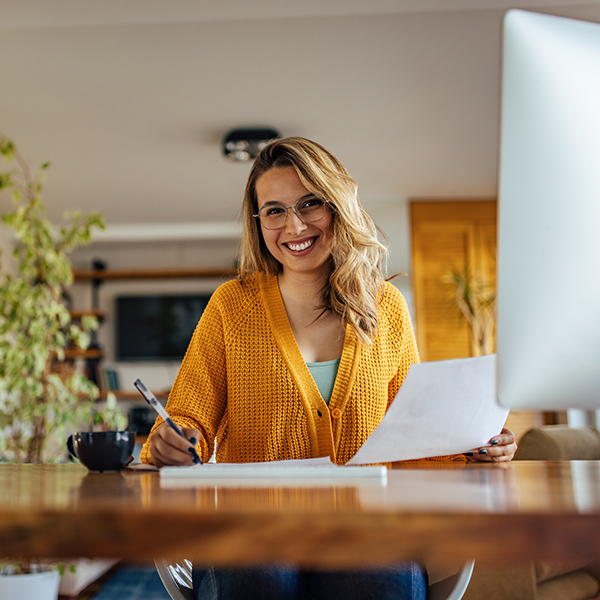 woman sitting with paperwork at a desk
